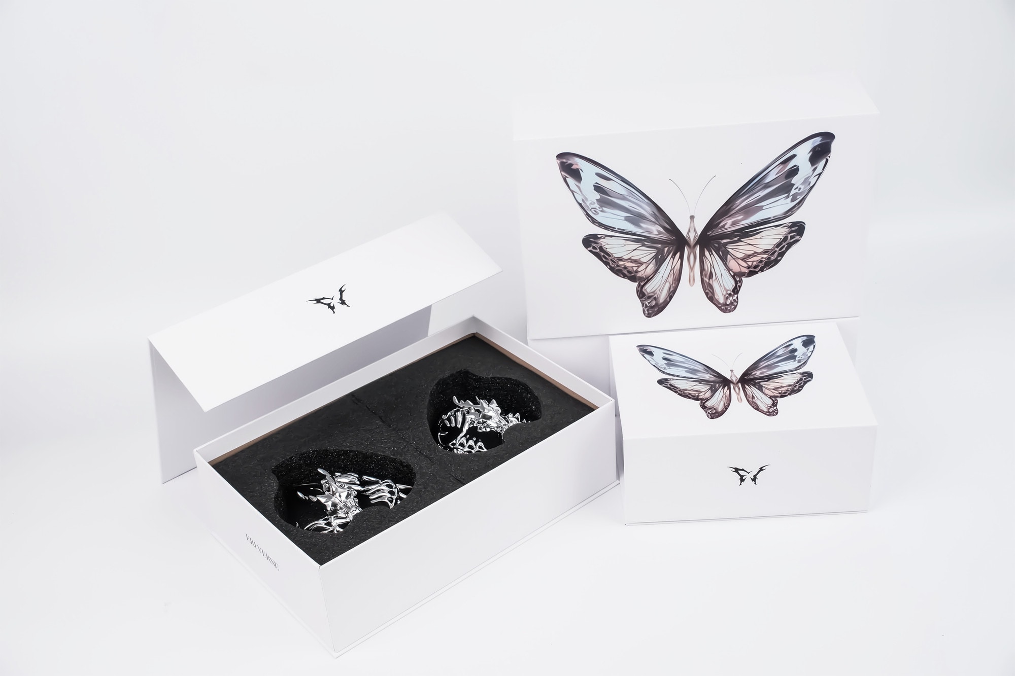 Eri Verse boxes with a pair of chrome pieces seated in black foam